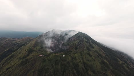 smokes rising from active batur volcano, aerial drone view