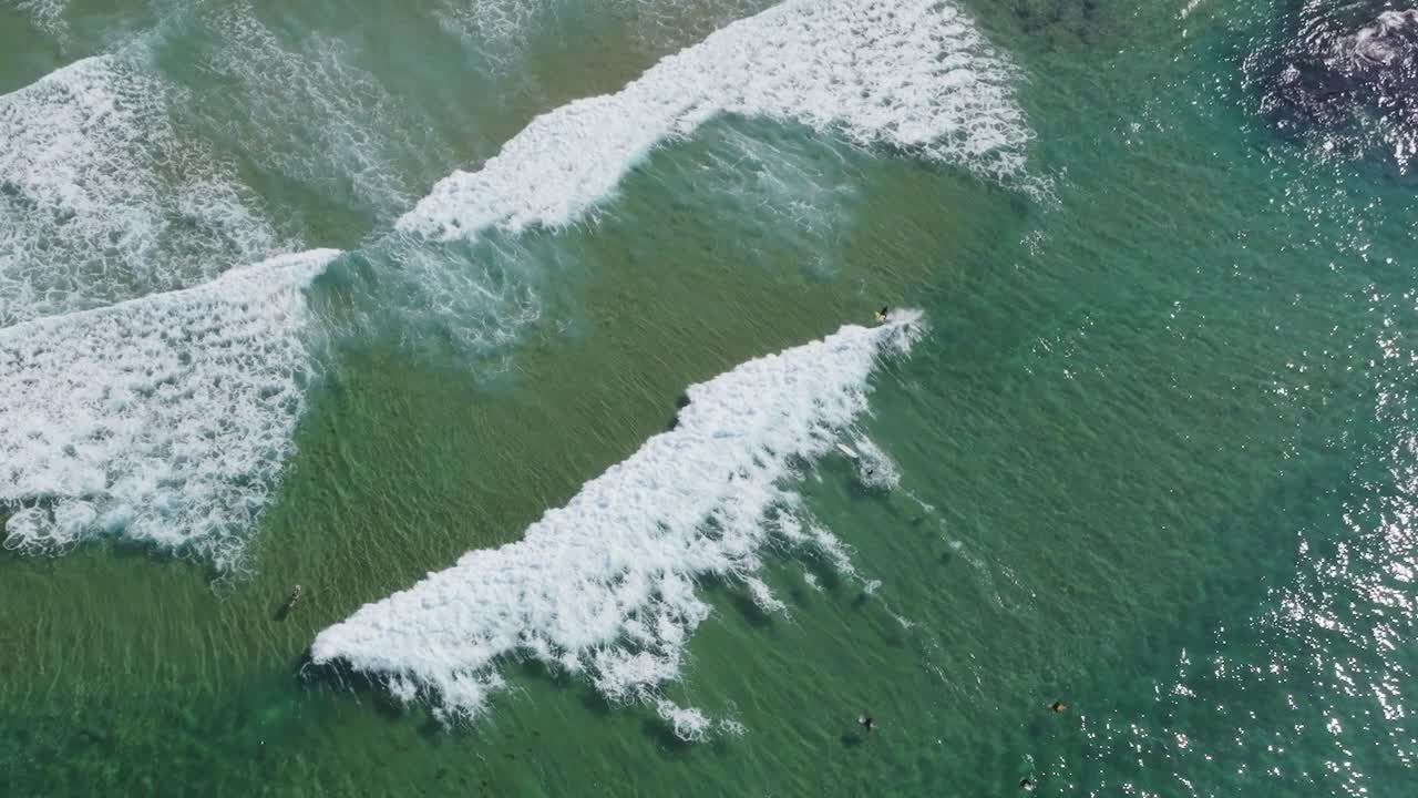 Drone footage captures the exhilarating energy of surfers riding the powerful waves of Medo de Fonte Santa, Portugal.
