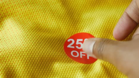 25% off sale sticker on yellow fabric