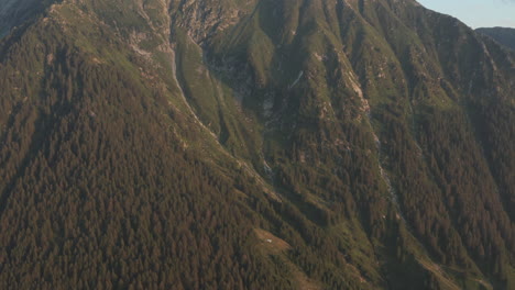 late sunset aerial drone tilt down reveal of northern italy mountain