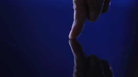 pulgar de hombre caucásico usando interfaz digital aplicando huella digital a la pantalla táctil