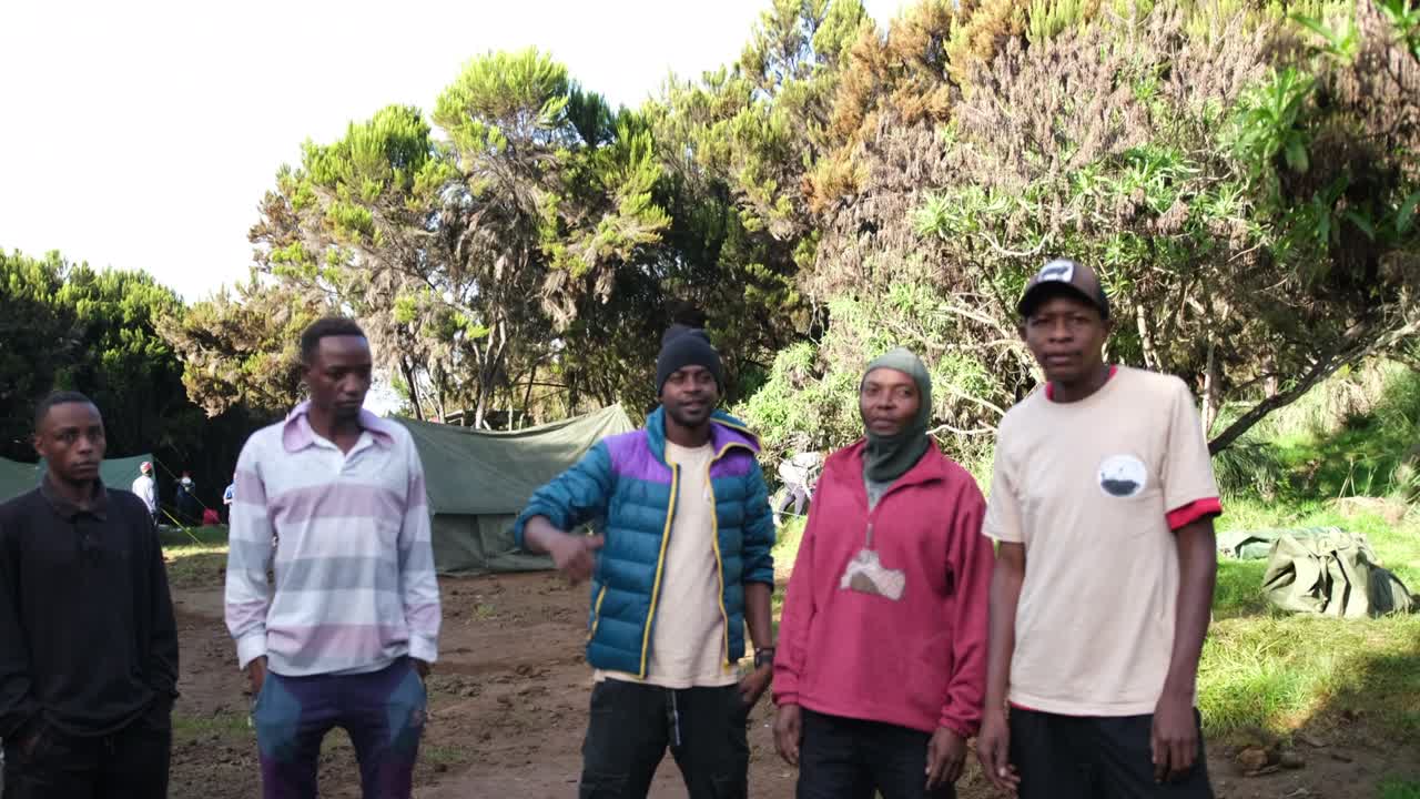 The guide gives the task to the camping team at Machame camp