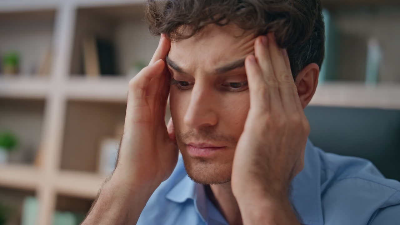 Tired entrepreneur examine papers closeup. Frustrated upset man rubbing temples