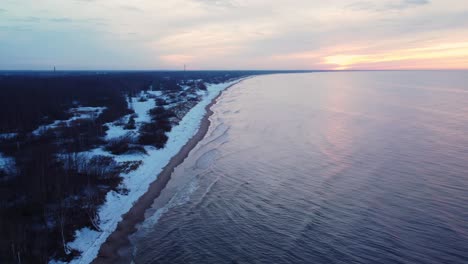 calm waves on the shore of the baltic sea, aerial view on blue hour