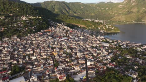 San-Pedro-town-at-lake-Atitlan-Guatemala-during-sunrise,-aerial