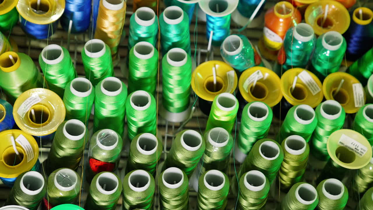 Collection of colorful threads. Different colors of threads in spools. Background of sewing threads. Handicraft concept.