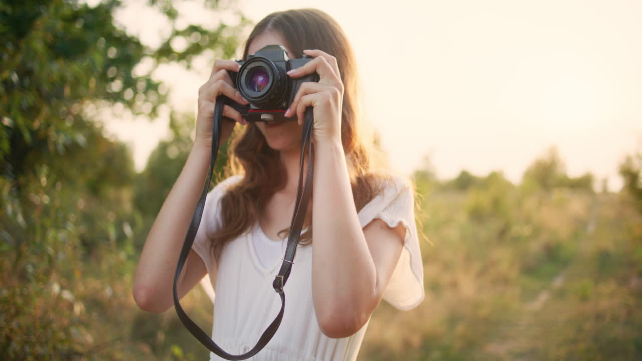 Smiling child takes photos in open fields