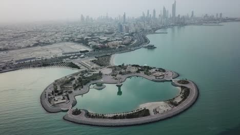 kuwait city waterfront (arabian gulf). skyline panoramic view, overcast weather. dynamic forward and tilt aerial shot