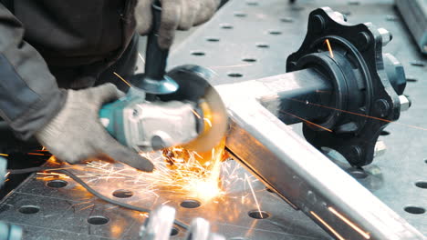 mechanic using metal grinder to polish metallic surface. bright flashes