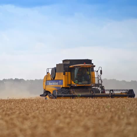 modern yellow-and-black harvester combine moving the agricultural field. working machinery on a busy harvest season. two combiners driving the vehicle