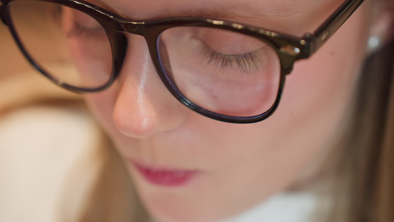 close up of woman bringing fork to mouth with creamy chocolate cake slice, highlighting texture of dessert and anticipation of taste as she gets ready to enjoy sweet treat in cozy setting