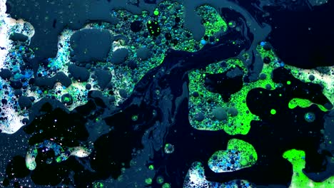 black, green and blue watercolor ink in water with oil. futuristic trend background.