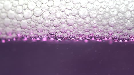 Closeup-of-soap-bubbles-on-a-purple-liquid