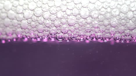 closeup of soap bubbles on a purple liquid