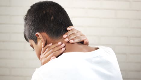 man suffering chronic neck pain