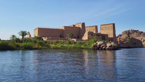 temple of philae exterior panoramic from the nile river at dawn