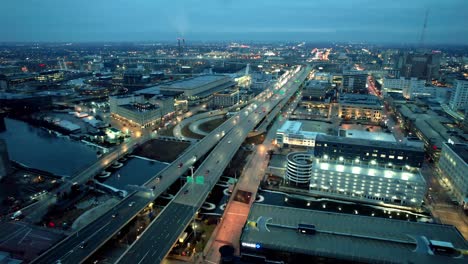 aerial-milwaukee-downtown-early-morning-with-cars,-trucks-driving-on-highway-i-794