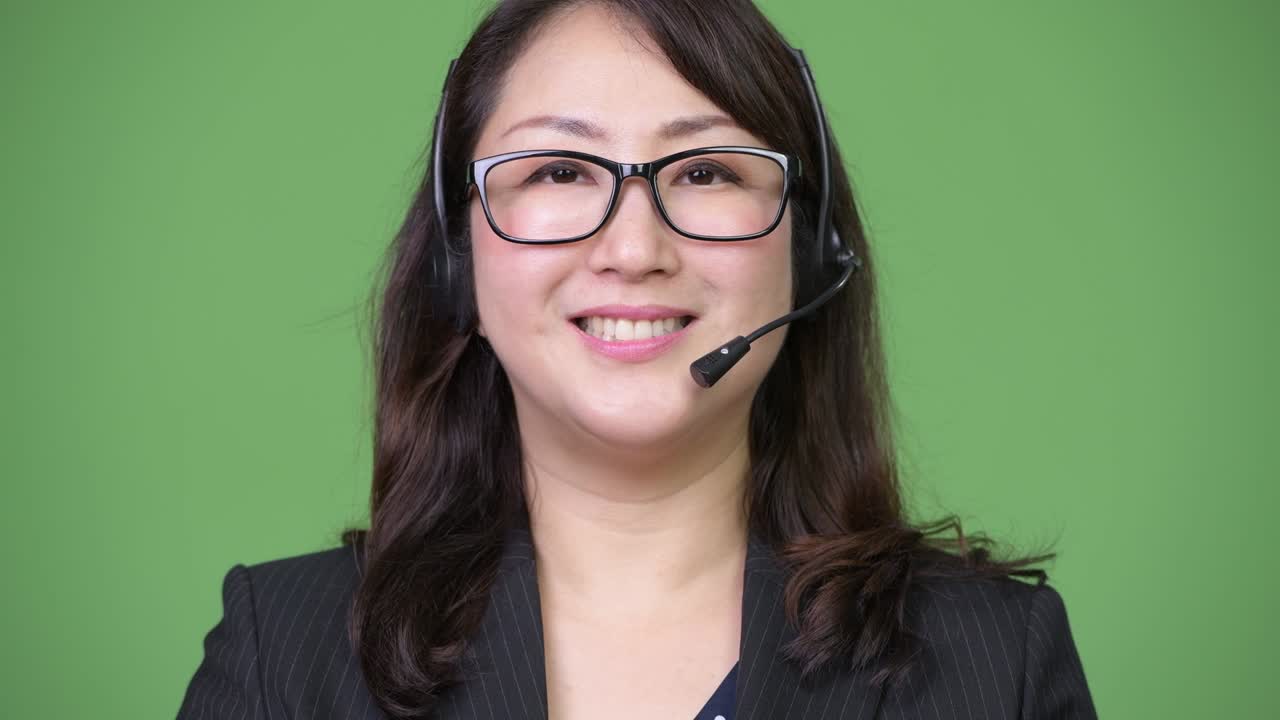 Mature beautiful Asian businesswoman working as call center representative