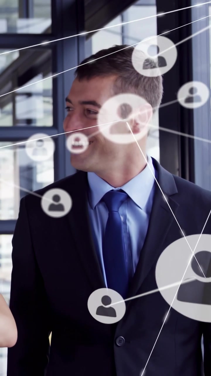 Vertical video: Man in suit turning to talking peer animated icons crossing him into biz network