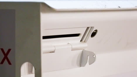 white mail slot for letters and envelopes with lock and red x close up