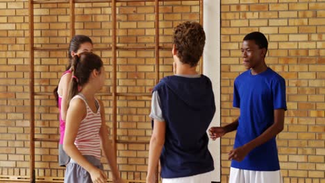 Group-of-happy-high-school-kids-giving-high-five-to-each-other