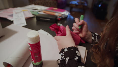 little girl crafting homemade christmas ornaments for the christmas tree