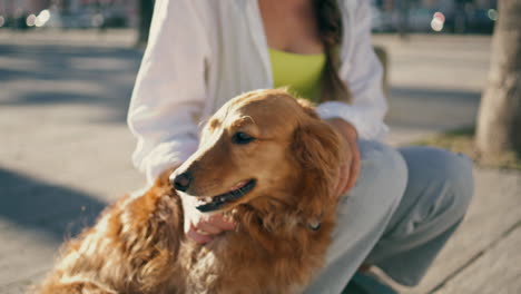 happy lady enjoying summer at boardwalk close up. woman kissing dog at street