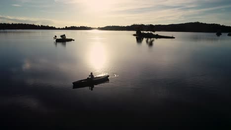 Hermoso-Amanecer-De-Colorado-En-Un-Lago-Con-Una-Silueta-De-Una-Canoa-Contra-El-Sol-Naciente