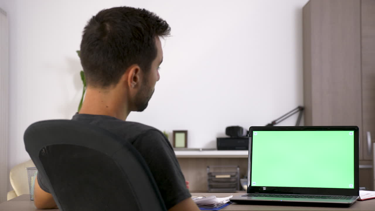 Workspace with Laptop and Green Screen