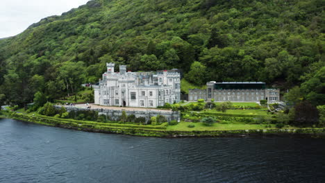 kylemore 수도원을 향한 pollacpal lough 위로 패닝 공중보기