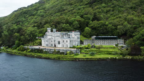 panning aerial view over pollacpal lough towards kylemore abbey