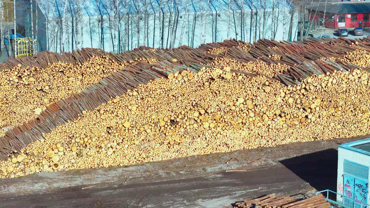 Isolated and stacked logs, uncut, drone shot in Latvia