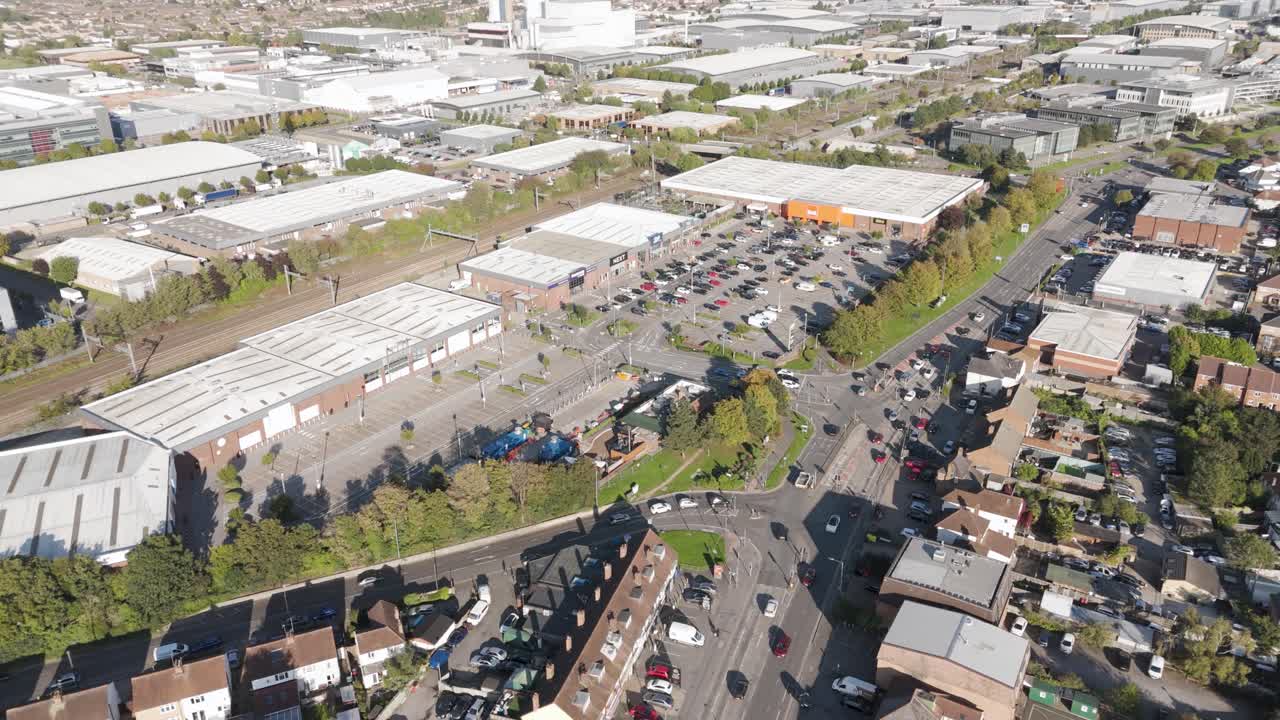 Aerial view of partially occupied retail park showing vacant units and parking infrastructure in Slough, Berkshire, UK, October 2024