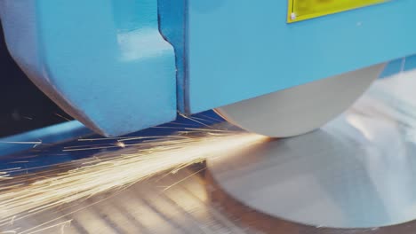 modern industrial equipment.the grinder machine is processing a round metal part.technological process close-up