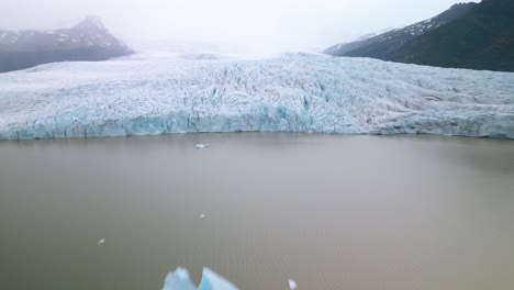 Aerial-Hyperlapse-Above-Glacial-Lake-with-Icebergs-formed-by-Melting-Glacier