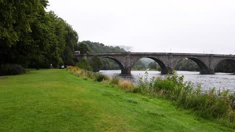 a tranquil view of a bridge and river