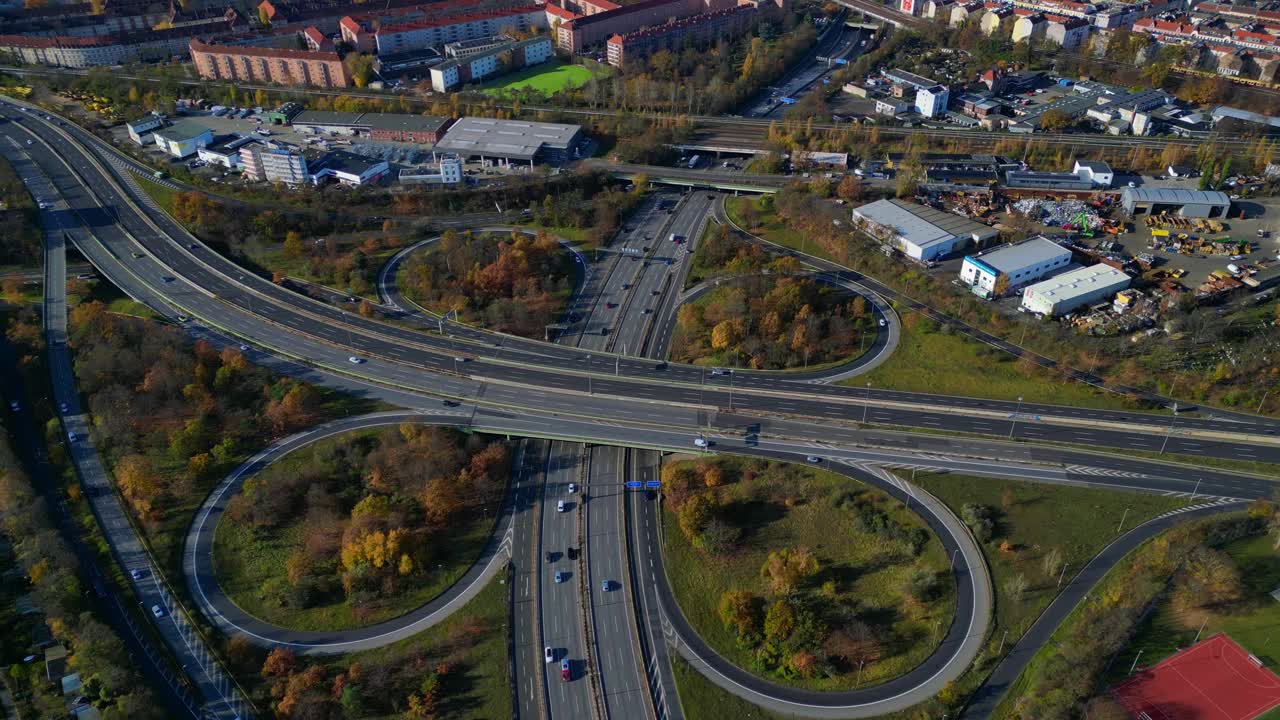 Complex highway interchange with cars traversing roads in Berlin. Bird's eye view drone camera pointing down. Smooth aerial view flight circle drone footage