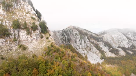 aerial footage of the lovcen national park and black lake with amazing fall colors everywhere with low clouds