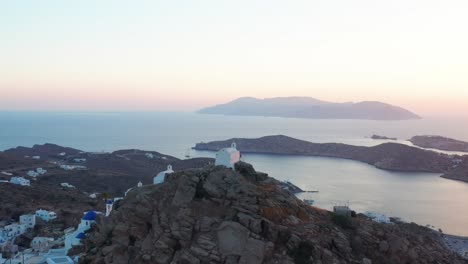 aerial view of ios chora circular pan shoot during sunset in greek island