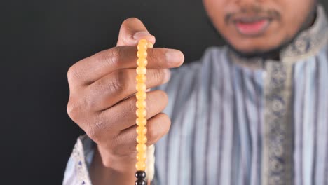 man holding prayer beads