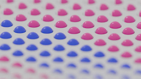 abstract pattern of pink and blue domes and hemispheres