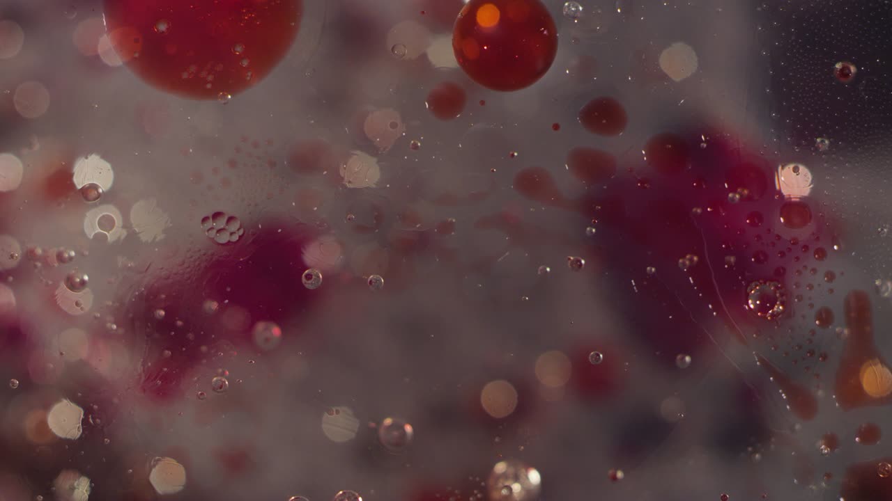 Abstract clear liquid bubbles and blood red splatter movement bokeh texture background