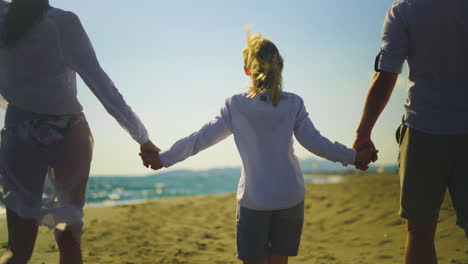 family walk on the beach
