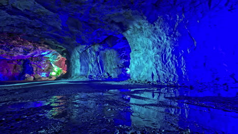 time lapse: inside cave of viking valley with colorful lights and flickering water - norway trip,europe