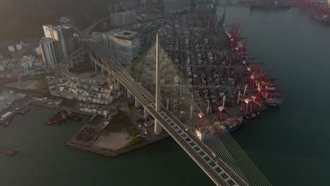 hong kong container terminal and port at victoria bay with full view of stonecutters bridge, storage terminal and docked ships, aerial footage