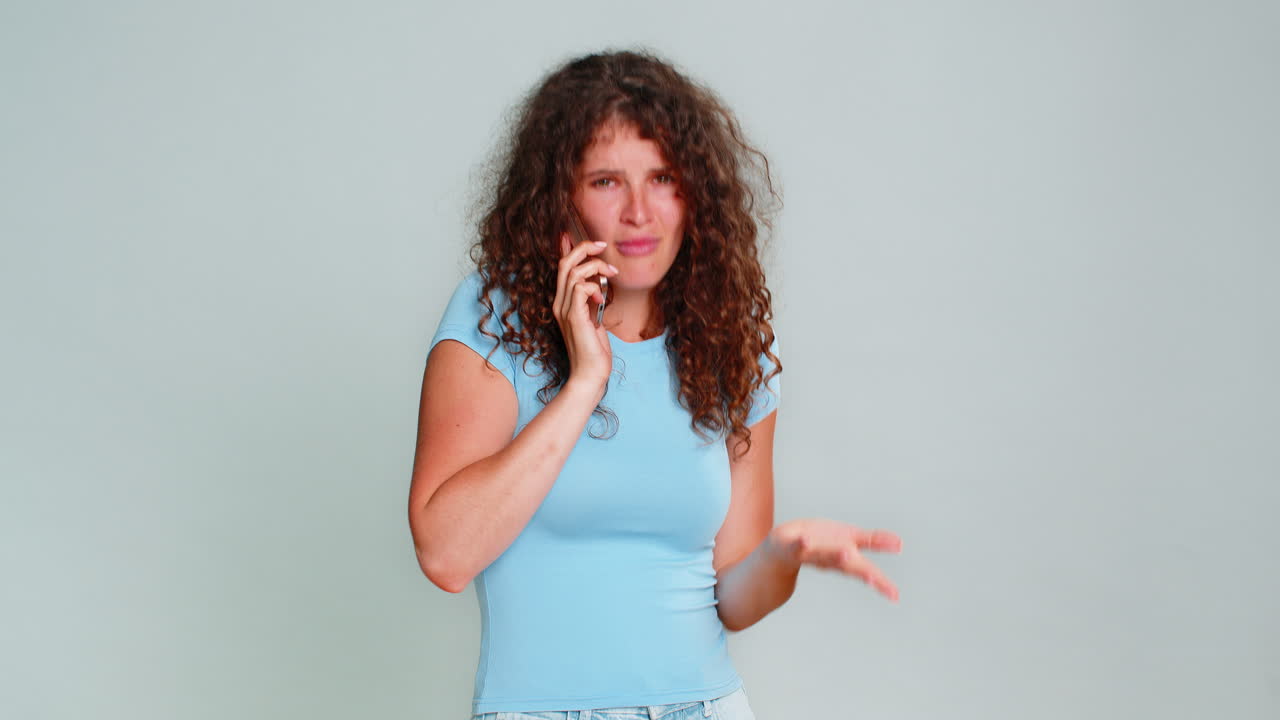 Woman talking smartphone phone call emotionally gesturing hands expressive animated conversation