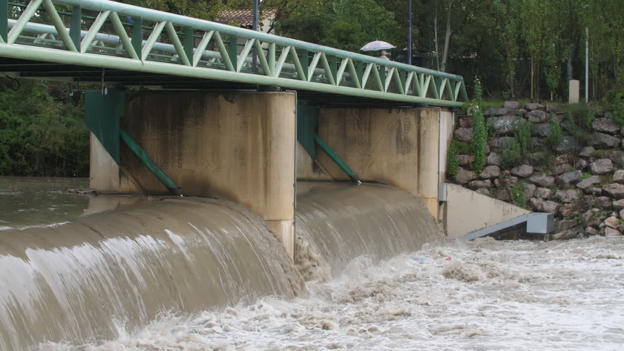 Heavy flowing river under a bridge Montpellier Antigone le Lez France heavy rain