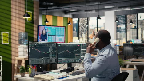 traders in office follow breaking news tv coverage of rare black swan event