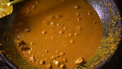 boiling meat on the pan is being stirred with a fork