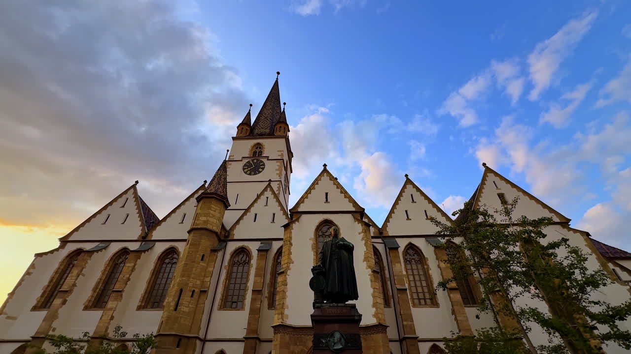 A monument at the front of the beautiful gothic building. Low angle view at the Lutheran Cathedral of Saint Mary in Sibiu, Romania